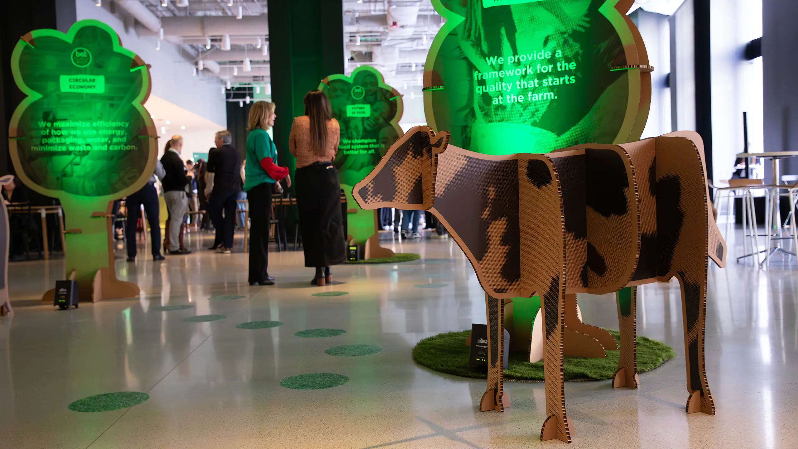 Cardboard interactive “trees,” in the lobby of the ‘All In 2025’ with information to inform attendees on food waste, portion control, regenerative agriculture, and the future of food