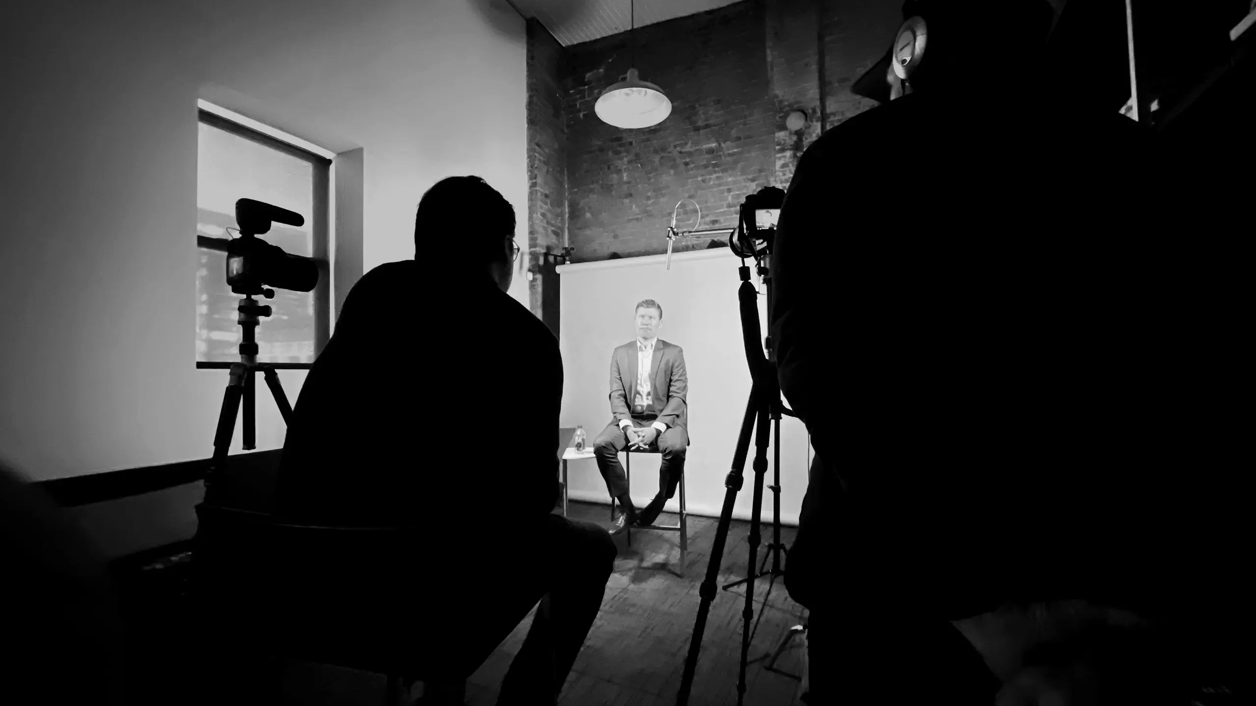 Behind-the-scenes video shoot at Multiple’s office, with a seated speaker framed by cameras, lighting, and crew in a studio-style setup.