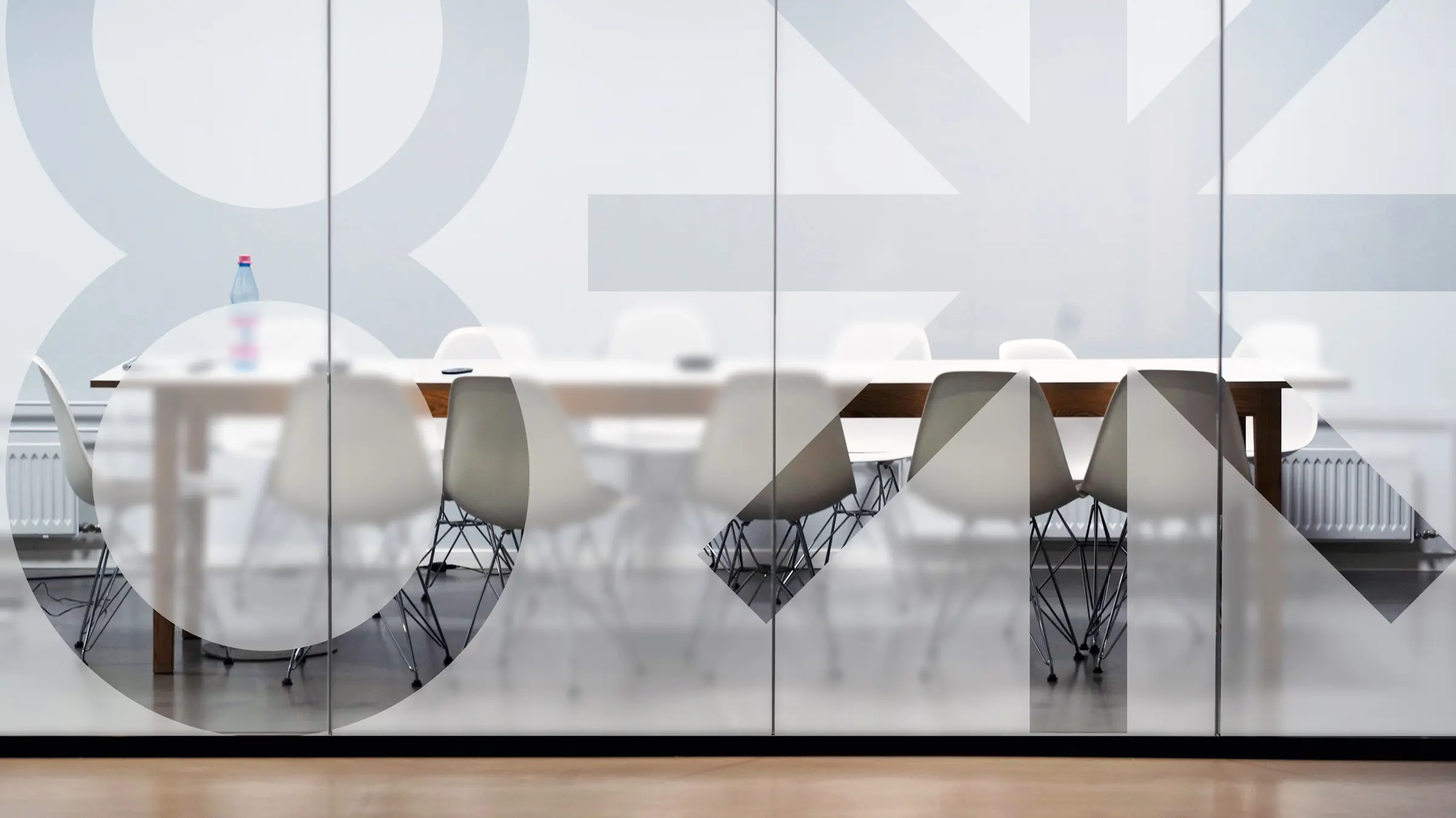 Eighth Light conference room glass windows with frosted glass and the logo