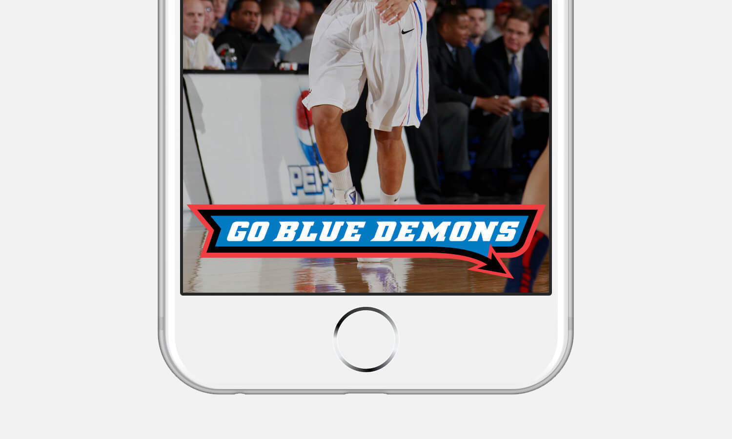 A smartphone screen shows a basketball player from the knees down, wearing white shorts and sneakers. The text "Go Blue Demons" is overlaid at the bottom.