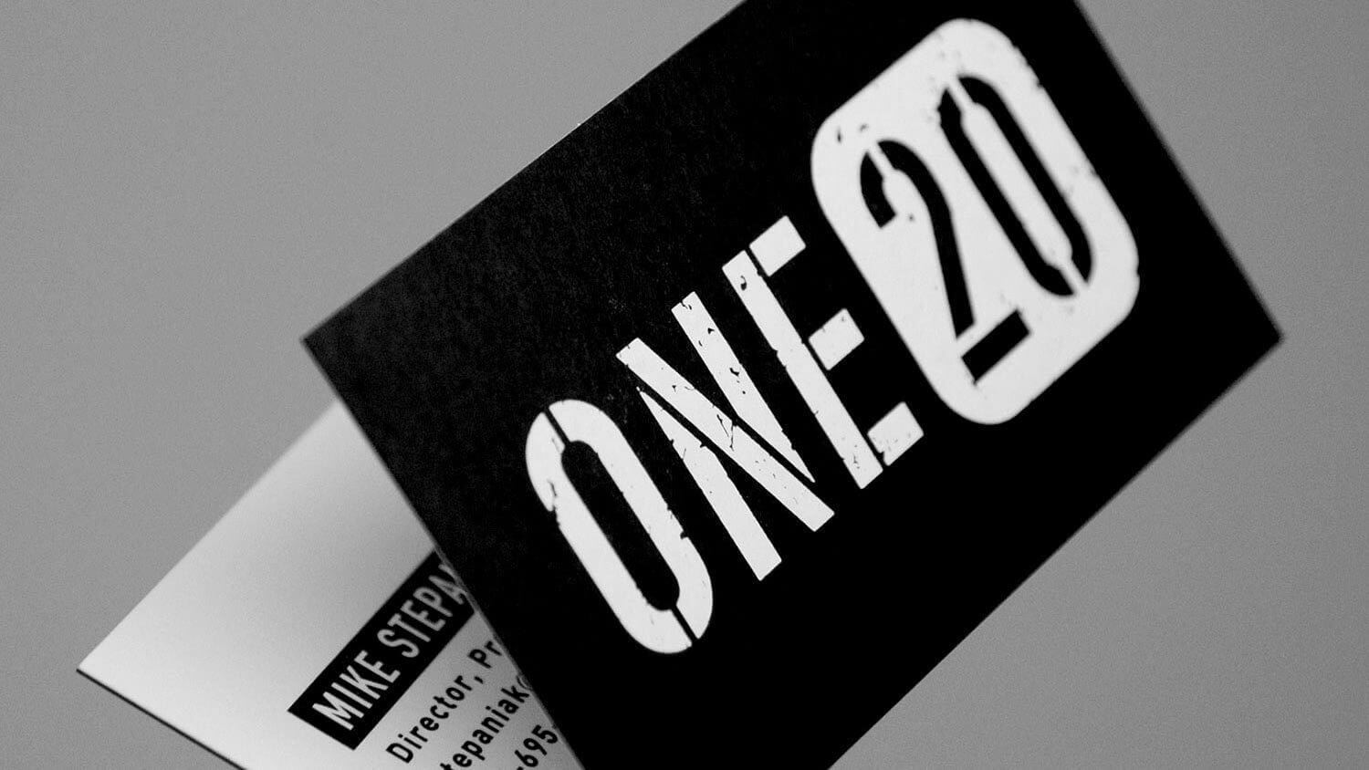 Black business card with bold, distressed white text reading "ONE20."