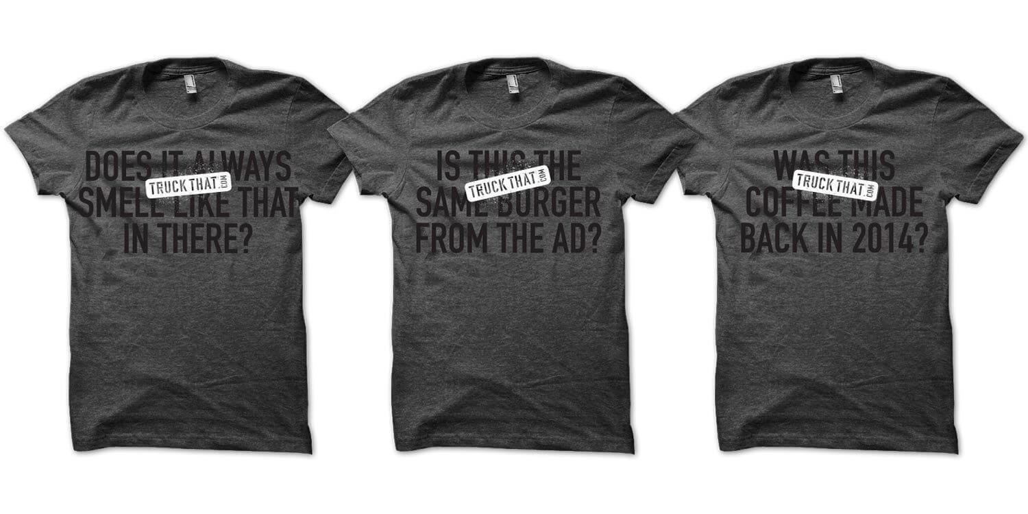 Three gray t-shirts with humorous phrases in bold black text. Each shirt features a small label reading "Truck That" in white, adding a playful touch.